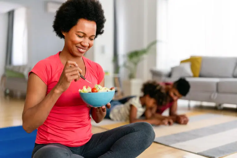 Woman eating a healthy bowl of fruit at home